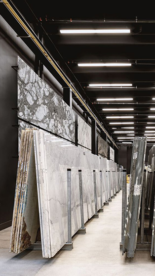 Large slab storage racks holding granite and marble slabs